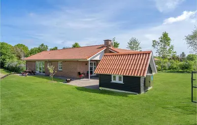 a small house with a red roof on a yard at Pet Friendly Home In Farsø With Sauna in Farsø