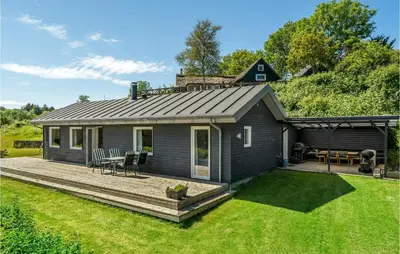 a home with a deck and a house at Cozy Home In Farsø With Sauna in Farsø
