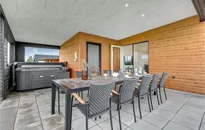 a dining room with a table and chairs at 4 Bedroom Awesome Home In Løgstrup in Løgstrup