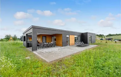 a small modular home in a field with grass at 4 Bedroom Awesome Home In Løgstrup in Løgstrup