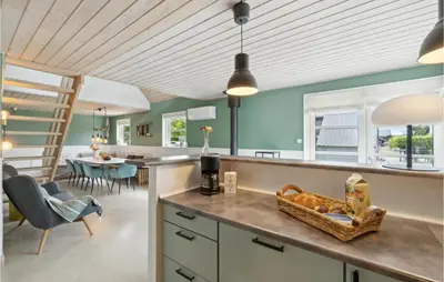 a kitchen with blue walls and a table and chairs at 3 Bedroom Beautiful Home In Farsø in Farsø