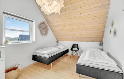 a bedroom with two beds and a wooden ceiling at 3 Bedroom Beautiful Home In Farsø in Farsø