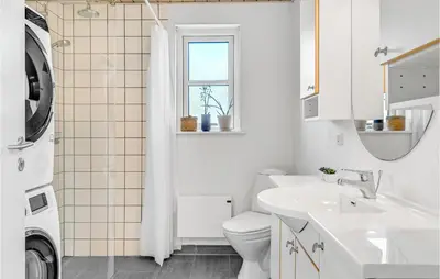 a white bathroom with a toilet and a sink at 3 Bedroom Beautiful Home In Farsø in Farsø