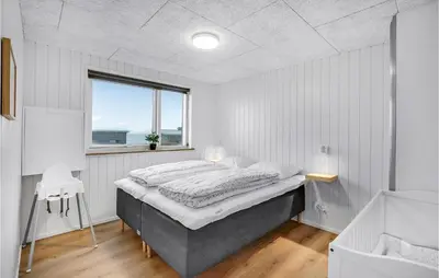 a bedroom with a large bed and a window at Lovely Home In Løgstrup With Wifi in Løgstrup
