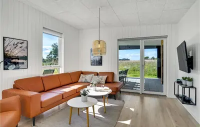 a living room with a couch and a table at 4 Bedroom Stunning Home In Løgstrup in Løgstrup