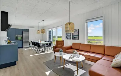 a living room with a couch and a table at 4 Bedroom Stunning Home In Løgstrup in Løgstrup