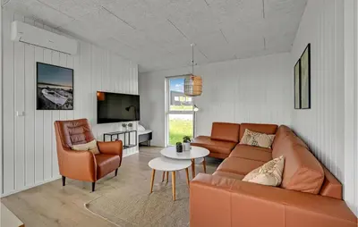 a living room with a couch and a table and chairs at Beautiful Home In Løgstrup With Kitchen in Løgstrup