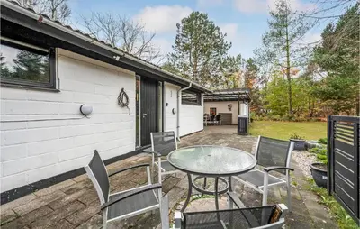 a patio with a table and chairs in front of a house at Lovely Home In Højslev With Wifi in Højslev