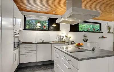 a kitchen with white cabinets and a wooden ceiling at Lovely Home In Højslev With Wifi in Højslev