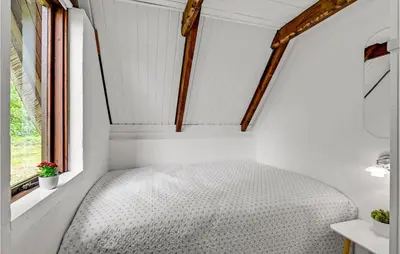 a bed in a small room with a window at Beautiful Home In Løgstrup With Wifi in Løgstrup