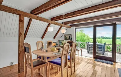 a dining room with a wooden table and chairs at Beautiful Home In Løgstrup With Wifi in Løgstrup