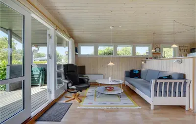 a living room with a couch and a table at Gorgeous Home In Farsø With Kitchen in Farsø