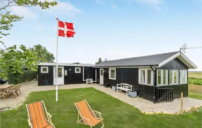 a house with a canadian flag in the yard at 1 Bedroom Beautiful Home In Løgstør in Løgstør