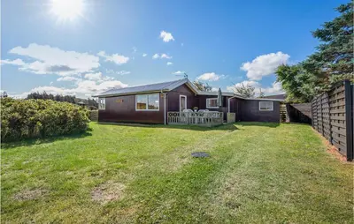a small house in a yard with a grass yard at 1 Bedroom Beautiful Home In Løgstør in Løgstør