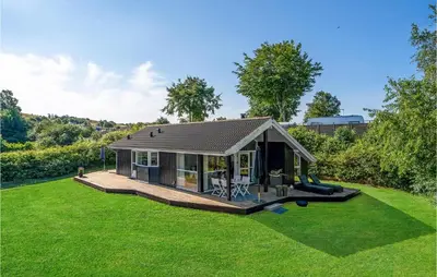 a small house with a large yard at Cozy Home In Løgstrup With Kitchen in Løgstrup