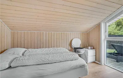a bedroom with a bed in a room with a window at Cozy Home In Løgstrup With Kitchen in Løgstrup