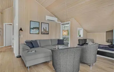 a living room with a gray couch and chairs at Cozy Home In Løgstrup With Kitchen in Løgstrup