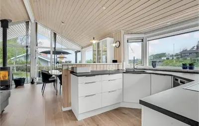 a kitchen with white cabinets and glass windows at Cozy Home In Løgstrup With Kitchen in Løgstrup