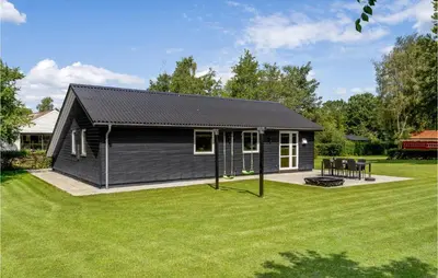 a black house with a large yard at Amazing Home In Farsø With Wifi in Farsø