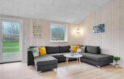 a living room with a couch and a table at Amazing Home In Farsø With Wifi in Farsø