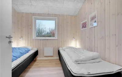 a bedroom with two beds and a window at Amazing Home In Farsø With Wifi in Farsø