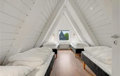 a room with four beds in a attic at 2 Bedroom Cozy Home In Farsø in Farsø