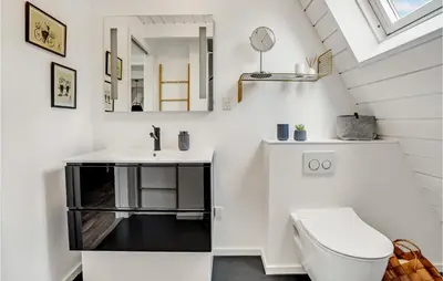 a bathroom with a sink and a toilet at 2 Bedroom Cozy Home In Farsø in Farsø