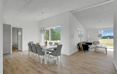 a white dining room with a table and chairs at 4 Bedroom Gorgeous Home In Løgstrup in Løgstrup