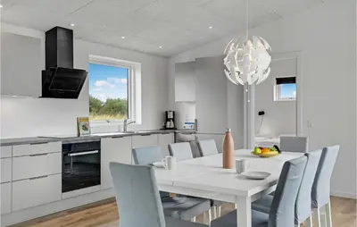 a kitchen and dining room with a white table and chairs at 4 Bedroom Gorgeous Home In Løgstrup in Løgstrup