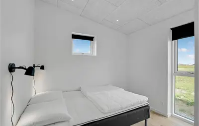 a white bedroom with a bed and a window at 4 Bedroom Gorgeous Home In Løgstrup in Løgstrup