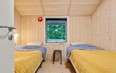 two beds in a room with a window at 3 Bedroom Cozy Home In Nibe in Nibe