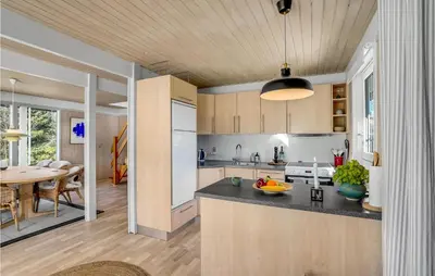 a kitchen and dining room with a dining table at 3 Bedroom Cozy Home In Højslev in Højslev