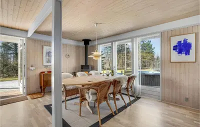 a dining room with a table and chairs at 3 Bedroom Cozy Home In Højslev in Højslev