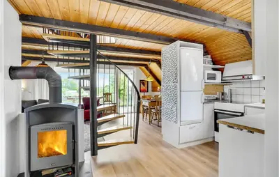 a kitchen with a wood stove in a room at Nice Home In Løgstrup With Wifi in Løgstrup