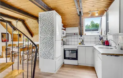 a kitchen with white appliances and a wooden ceiling at Nice Home In Løgstrup With Wifi in Løgstrup
