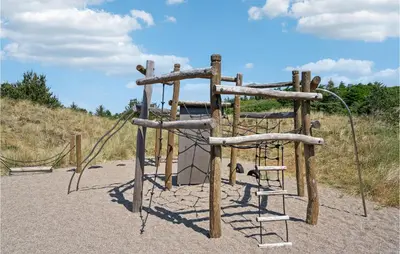an outdoor playground with a rope swing at Amazing Home In Blokhus With Wifi in Blokhus