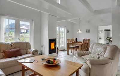 a living room with a couch and a table at Amazing Home In Blokhus With Wifi in Blokhus