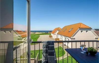 a balcony with a table and a view of the ocean at Stunning Apartment In Lemvig With Wifi in Lemvig