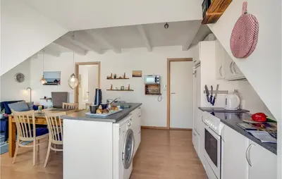a kitchen with a washer and dryer and a dining room at Stunning Apartment In Lemvig With Wifi in Lemvig