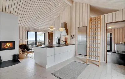a kitchen with white cabinets and a stove at 3 Bedroom Stunning Home In Thyholm in Thyholm