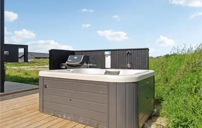 a bath tub sitting on a wooden deck at 3 Bedroom Amazing Home In Thisted in Thisted