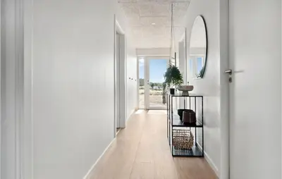 a hallway with white walls and a mirror at 3 Bedroom Amazing Home In Thisted in Thisted