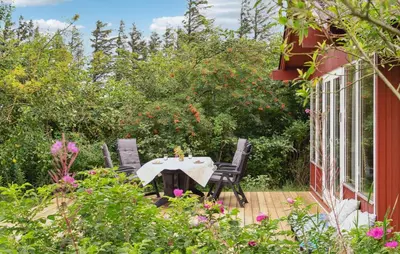 a patio with a table and chairs on a deck at 3 Bedroom Cozy Home In Spøttrup in Spottrup