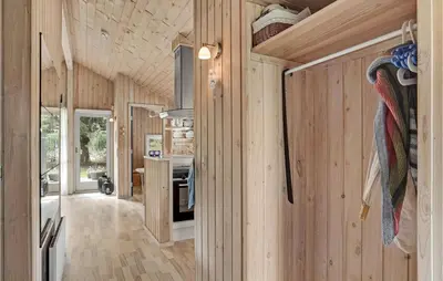 a kitchen and living room in a tiny house at 3 Bedroom Amazing Home In Pandrup in Pandrup