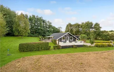 a small house in the middle of a yard at Lovely Home In Roslev With Wifi in Roslev