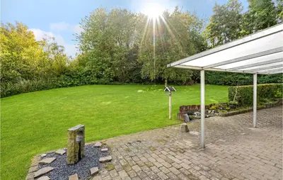 a backyard with a white canopy and a grass field at Lovely Home In Roslev With Wifi in Roslev