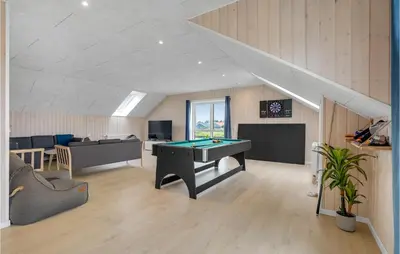 a living room with a pool table and a couch at Lovely Home In Thisted in Thisted