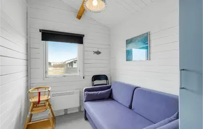 a living room with a purple couch and a window at 2 Bedroom Beautiful Home In Thisted in Thisted