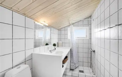 a white bathroom with a sink and a toilet at 2 Bedroom Beautiful Home In Thisted in Thisted