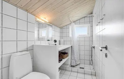 a white bathroom with a toilet and a sink at 2 Bedroom Beautiful Home In Thisted in Thisted